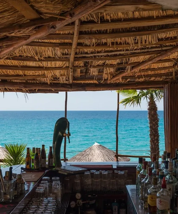 View over the bar counter, out to the turquoise Aegean